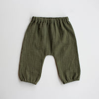 The Baby/Child August Pants sewing pattern from Oh Me Oh My Sewing on The Fold Line. A trousers pattern made in quilting cotton, washed linen, cotton lawn, or double gauze fabric, featuring an elastic waist and legholes and a gathered bubble silhouette.