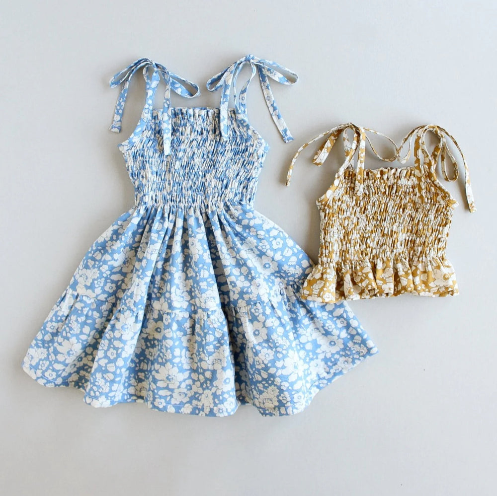 The Baby/Child Bluebell Dress and Top sewing pattern from Oh Me Oh My Sewing on The Fold Line. A dress and top pattern made in voile, lawn, or single or double gauze fabric, featuring a shirred bodice and tie straps.