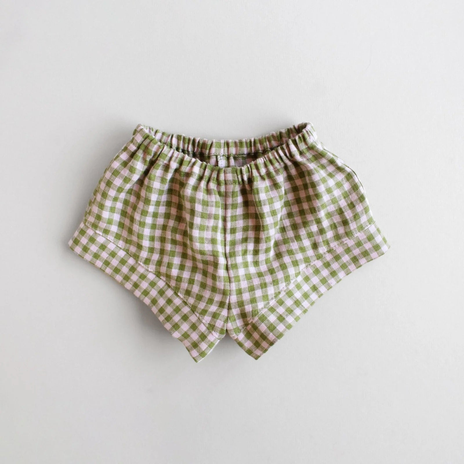 The Baby/Child Fauna Shorts sewing pattern from Oh Me Oh My Sewing on The Fold Line. A shorts pattern made in quilting cotton, washed linen, double gauze, cotton lawn, voile, or rayon challis fabric, featuring an elastic waist and comfy fit.