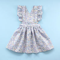 The Baby/Child Flutter Pinafore Dress sewing pattern from Oh Me Oh My Sewing on The Fold Line. A dress pattern made in quilting cotton, washed linen, double gauze, cotton lawn, voile, or rayon challis fabric, featuring a bib with ruffled straps and a full gathered skirt.