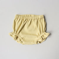 The Baby/Child Juniper Bloomers sewing pattern from Oh Me Oh My Sewing on The Fold Line. A bloomers pattern made in double gauze, waffle knit, jersey, or rib knit fabric, featuring a bubble silhouette, elastic waist, and elastic legholes with ruffles.