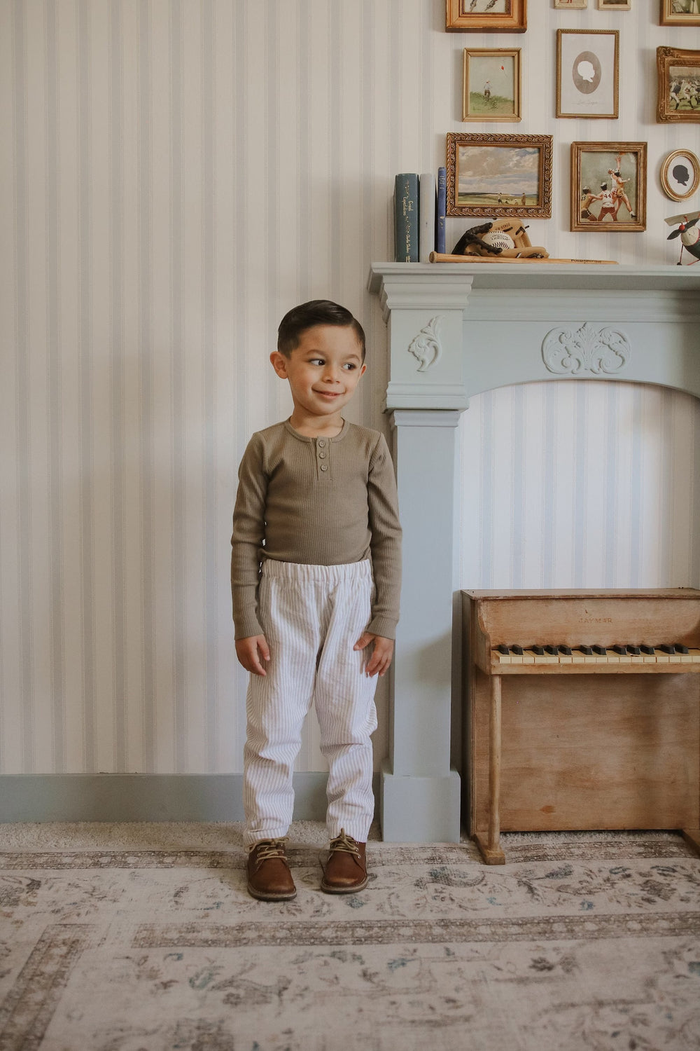 Boy wearing the Baby/Child Sunday Pants sewing pattern from Me & Kiddo Patterns on The Fold Line. A trousers pattern made in linen or cotton fabric, featuring a relaxed fit and elastic waist.