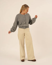 Woman wearing the Balloon Cardigan sewing pattern from Wardrobe by Me on The Fold Line. A cardigan pattern made in jersey knit fabric, featuring a slightly oversized fit, round neckline, dropped shoulders, button front, and balloon sleeves.