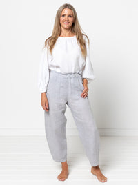 Woman wearing the Barry Woven Pant sewing pattern from Style Arc on The Fold Line. A trousers pattern made in washed linen, tencel, crepe, or fine wool fabric, featuring an elastic waistband with a top ruffle, faux fly, angled pockets, and slight balloon leg shape.