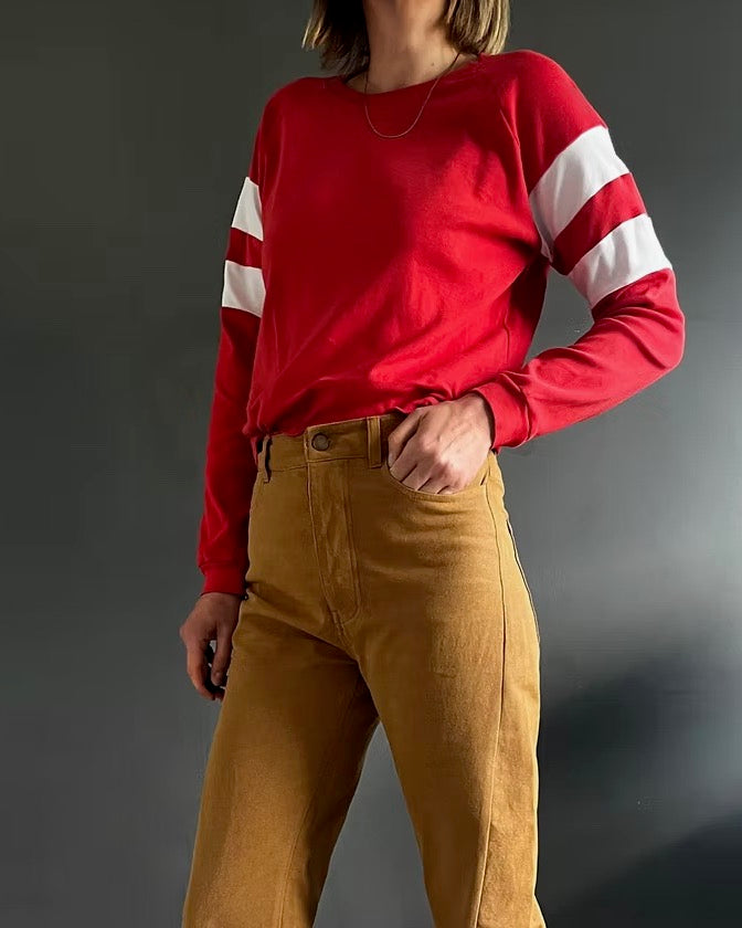Woman wearing the Bastian Sweatshirt sewing pattern from French Navy on The Fold Line. A top pattern made in sweatshirt fabric, featuring a round neckline and long raglan sleeves with contrast stripes.
