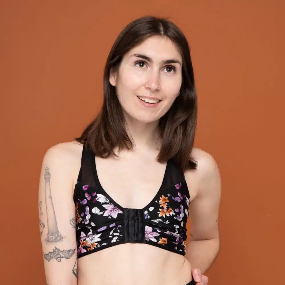 Woman wearing the Bianca Mastectomy Bra sewing pattern from Madalynne on The Fold Line. A bralette pattern made in lycra or cotton jersey fabric, featuring a racerback design, adjustable shoulder straps, hook and eye front closure, enclosed seams, and pockets for drains or prostheses. 
