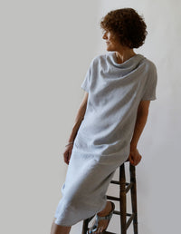 Woman wearing the Bias Dress sewing pattern from The Maker's Atelier on The Fold Line. A dress pattern made in silk, tencel, viscose, or lightweight linen fabric, featuring a bias cut, draped neckline, and grown-on short sleeves.