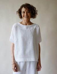 Woman wearing the Boat Neck Top sewing pattern from The Maker's Atelier on The Fold Line. A top pattern made in cotton, linen, denim, chambray, tencel, or viscose fabric, featuring a relaxed fit, boat neck, and grown-on short sleeves. 