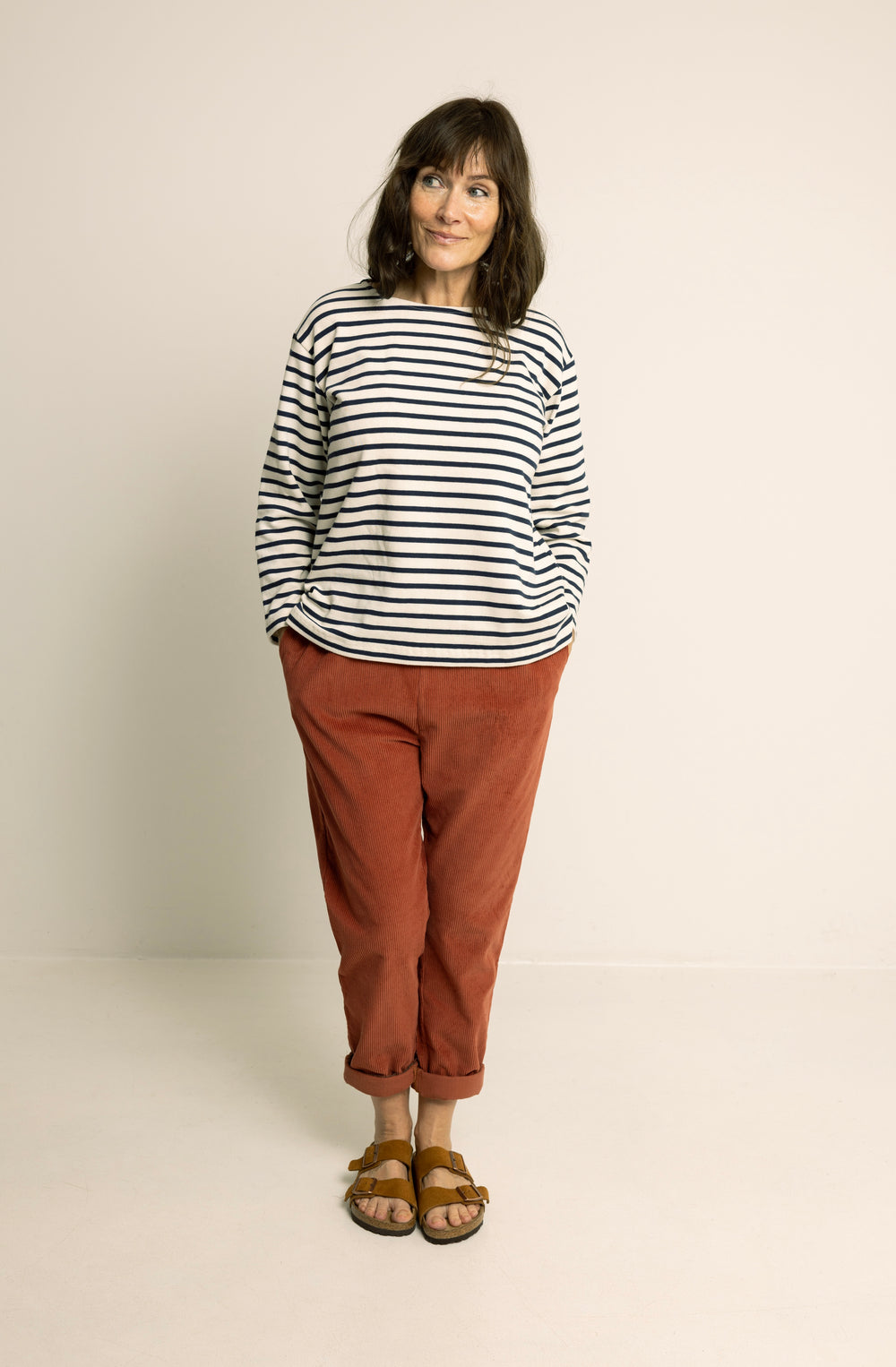 Woman wearing the Boatneck Top sewing pattern from Wardrobe by Me on The Fold Line. A top pattern made in jersey knit fabric, featuring a relaxed fit, boat neckline, and long sleeves.