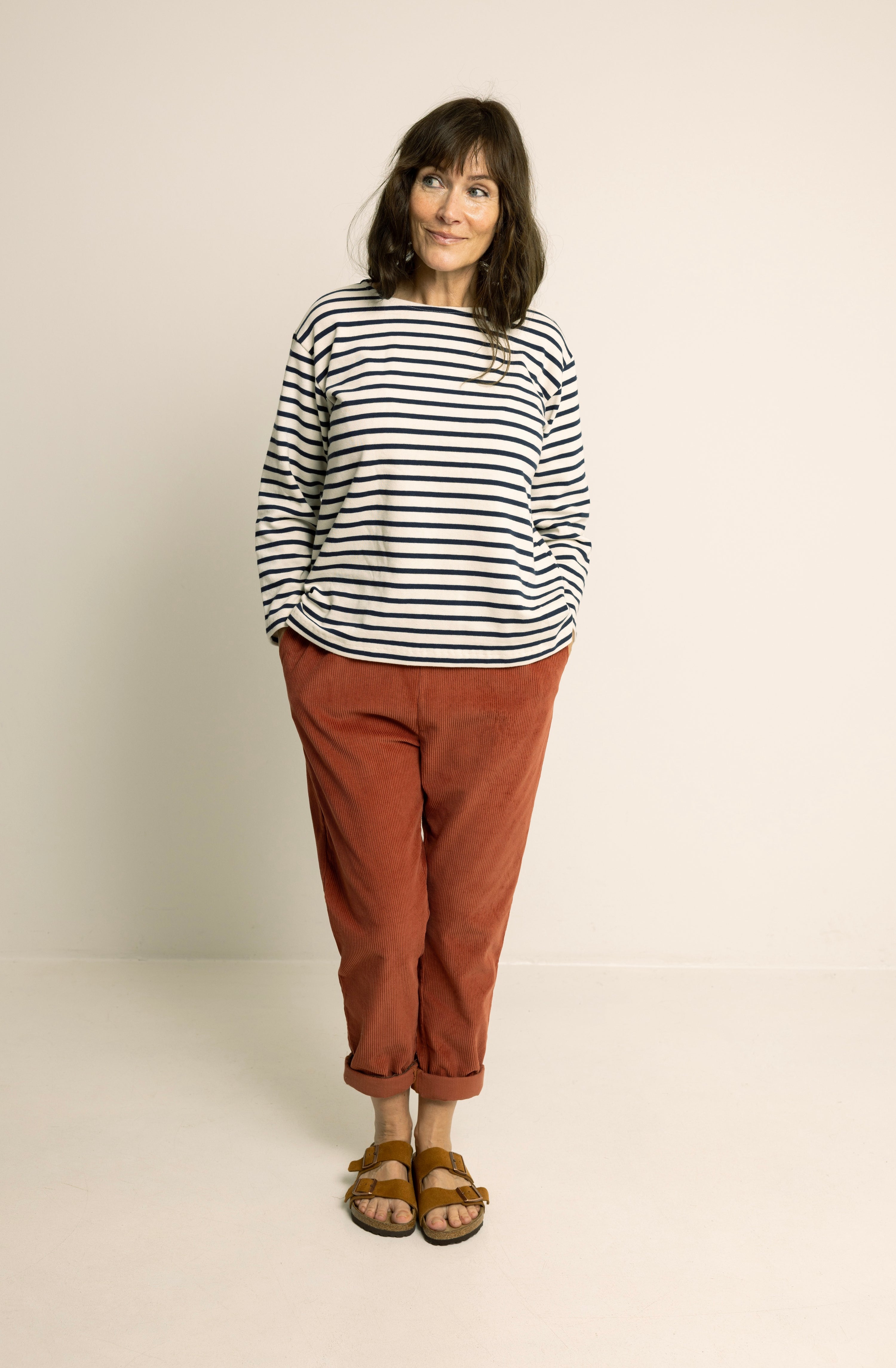 Woman wearing the Boatneck Top sewing pattern from Wardrobe by Me on The Fold Line. A top pattern made in jersey knit fabric, featuring a relaxed fit, boat neckline, and long sleeves.