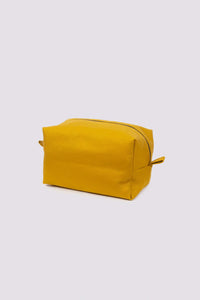 The Boxy Toiletries Bag sewing pattern from Sew Over It on The Fold Line. A bag pattern made in quilting cotton or cotton canvas fabric, featuring a boxy shape, zip top, and end tabs.