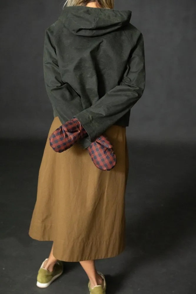 Woman wearing the Braemar Mittens sewing pattern from Merchant & Mills on The Fold Line. A mittens pattern made in oilskin, dry oilskin, mid weight cotton canvas or drill, corduroy, mid-heavy weight denim, or wool coating fabric, featuring a lining and rib cuff.