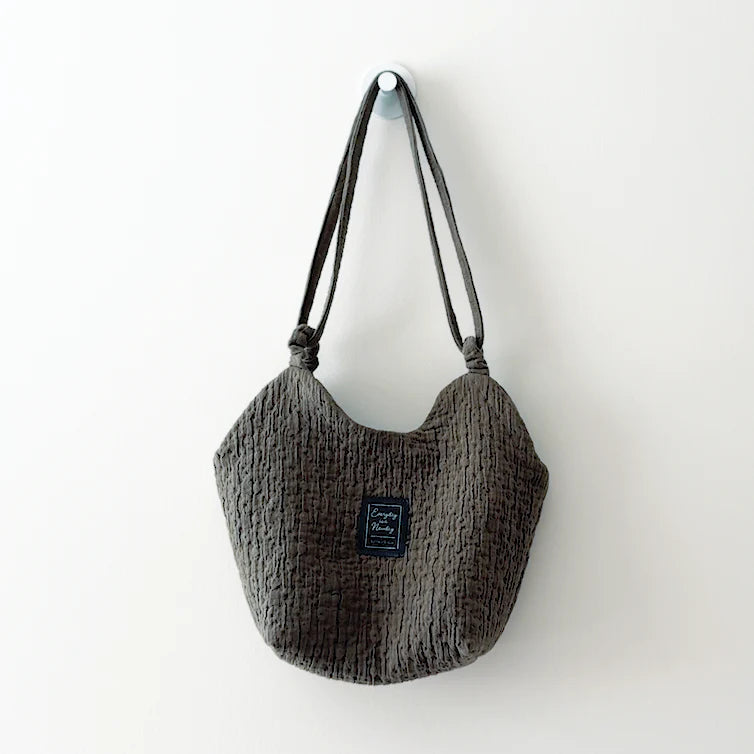 The Bridge Bag sewing pattern from Sewing Therapy on The Fold Line. A bag pattern made in cotton canvas, heavy linen, cotton/linen blends, denim, or home décor fabric, featuring a twin-peak silhouette and continuous loop strap system.