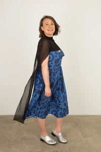 Woman wearing the Bronte Cape sewing pattern from Sew Over It on The Fold Line. A cape pattern made in knit or mesh fabric, featuring a cowl neckline and long flowing panels.
