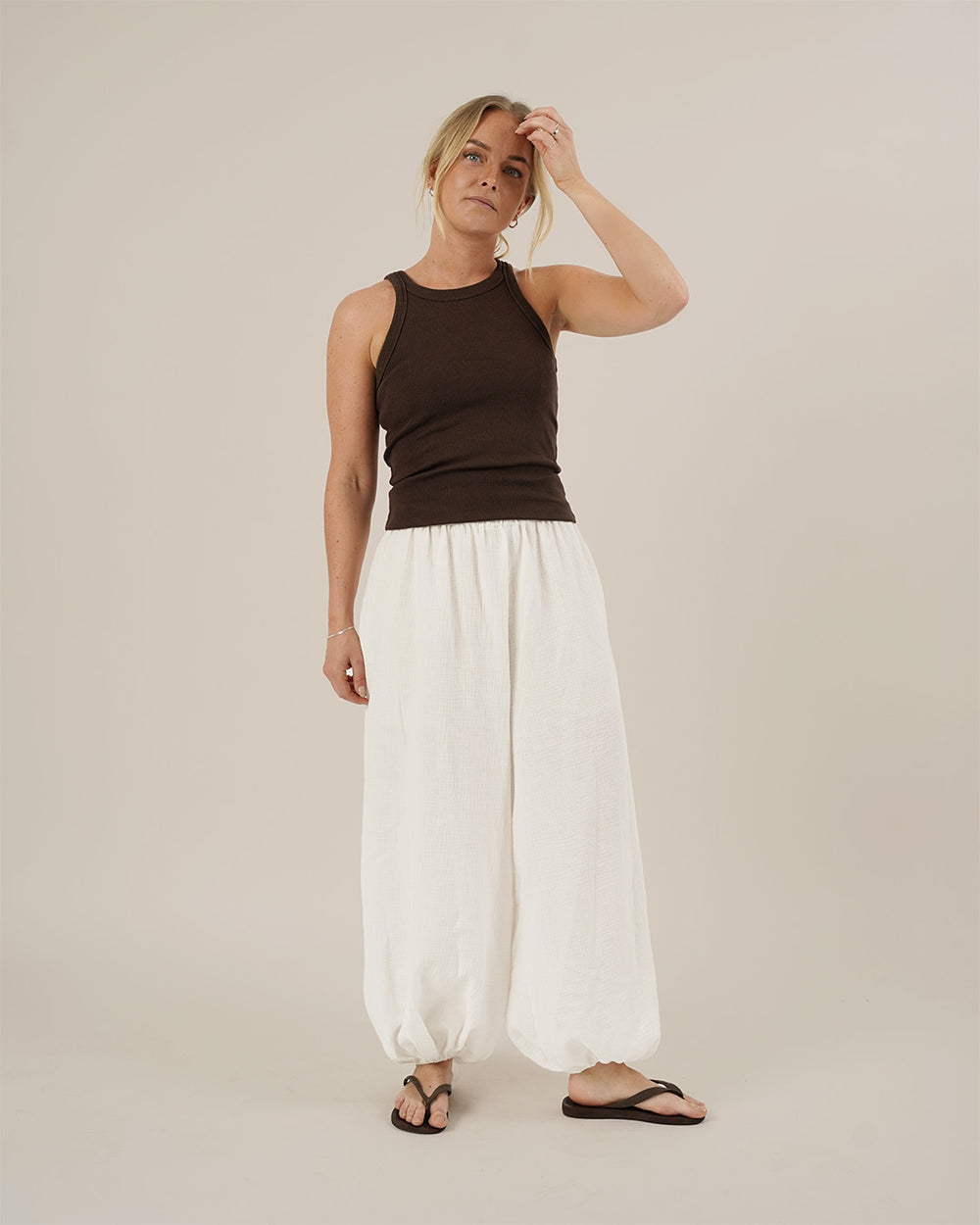 Woman wearing the Bubble Pants sewing pattern from Wardrobe by Me on The Fold Line. A trousers pattern made in cotton, linen, double gauze, or seersucker fabric, featuring a voluminous silhouette, elastic waist, and elastic hems.