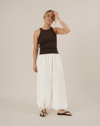 Woman wearing the Bubble Pants sewing pattern from Wardrobe by Me on The Fold Line. A trousers pattern made in cotton, linen, double gauze, or seersucker fabric, featuring a voluminous silhouette, elastic waist, and elastic hems.