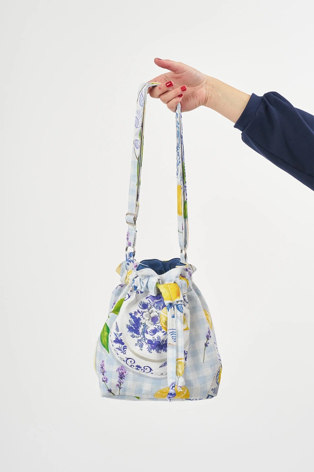 The Bucket Bag sewing pattern from Sew Over It on The Fold Line. A bag pattern made in cotton twill, cotton canvas, or denim fabric, featuring a classic drawstring fastening, flat base, full lining, inside pocket, and adjustable strap.