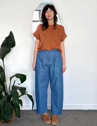Woman wearing the Burwood Jeans sewing pattern from In the Folds on The Fold Line. A jeans pattern made in denim, cotton drill, or canvas fabric, featuring a zip fly, pleats, pockets, topstitching, barrel leg, and ankle length.