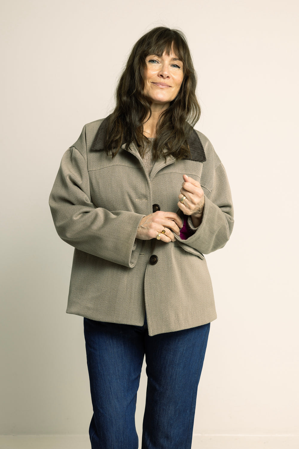 Woman wearing the Car Coat sewing pattern from Wardrobe by Me on The Fold Line. A coat pattern made in wool fabric, featuring a boxy fit, dropped shoulders, convertible collar, front and back yokes, deep armholes, welt pockets, and button closure.