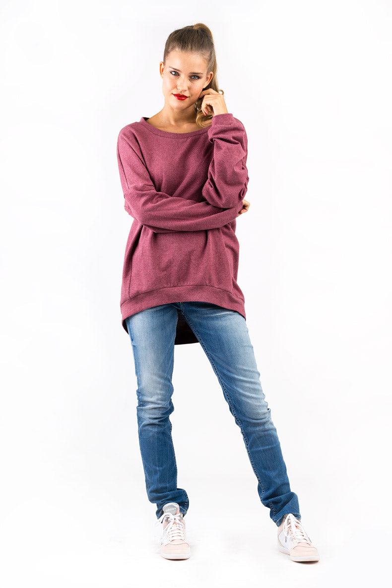 Woman wearing the Catrin Sweatshirt sewing pattern from Schnittchen Patterns on The Fold Line. A sweatshirt pattern made in sweatshirt or jersey fabric, featuring an oversized fit, batwing sleeves, inlays along the side seams, and cuffs at the wrists and hem.