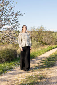 Woman wearing the Celeste Top sewing pattern from Silversaga Patterns on The Fold Line. A blouse pattern made in soft cotton, cotton lawn or voile, or cotton poplin fabric, featuring a round neckline, adjustable gathers, gently flared peplum, and long sleeves.