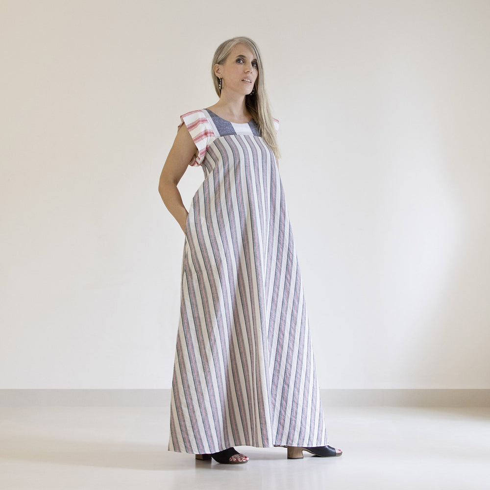 Woman wearing the Celestial Dress sewing pattern from Pattern Fantastique on The Fold Line. A dress pattern made in viscose, silk, linen, cotton, or denim fabric, featuring a round neckline, pockets, and maxi length.