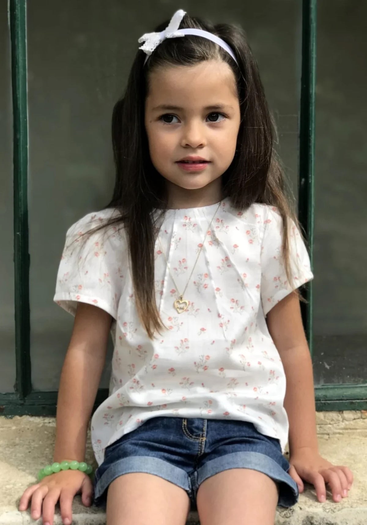 Girl wearing the Miss Zenith Blouse sewing pattern from Maison Fauve on The Fold Line. A top pattern featuring a round neckline, sunray effect bodice, and short gathered sleeves.