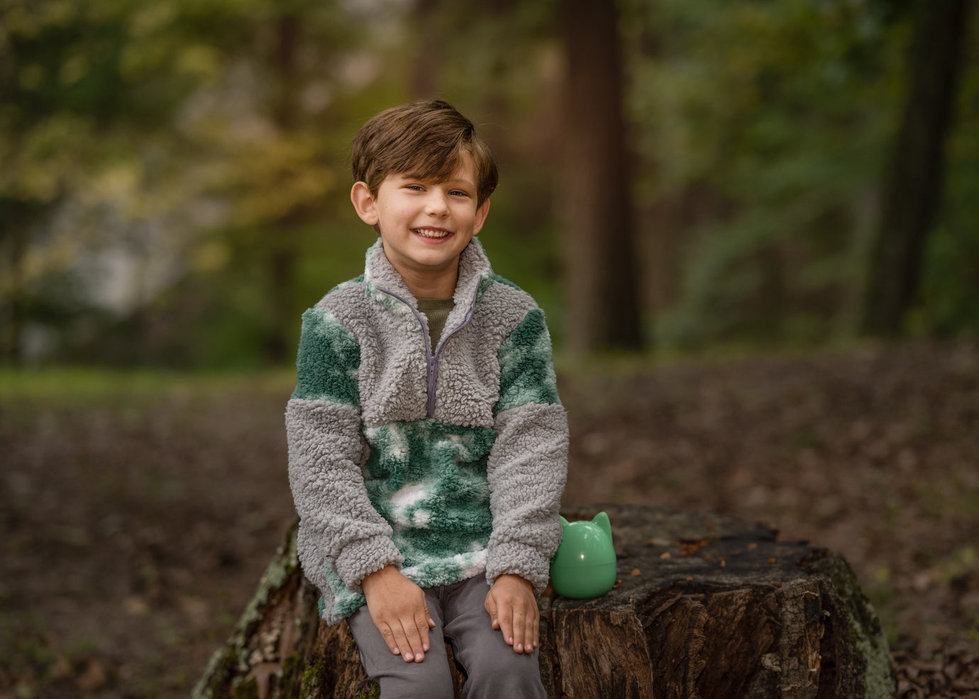 Boy wearing the Children's Quokka Quarter Zip Top sewing pattern from Waves & Wild on The Fold Line. A top pattern made in medium weight knit, sweatshirt fleece, or alpine fleece fabric, featuring a relaxed fit, high collar, and long sleeves.