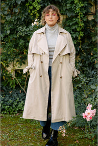 Woman wearing the Chloe Trench Coat sewing pattern from JULIANA MARTEJEVS on The Fold Line. A trench coat pattern made in viscose twill fabric, featuring a relaxed fit, oversized collar, and ties on the cuffs.