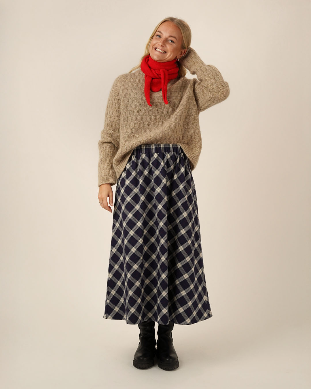 Woman wearing the Claude Skirt sewing pattern from Wardrobe by Me on The Fold Line. A skirt pattern made in cotton, denim, baby cord, or viscose fabric, featuring an elastic waistband, side seam pockets, and midi length.