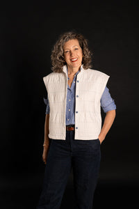 Woman wearing the Condesa Quilted Vest sewing pattern from Liesl + Co on The Fold Line. A quilted sleeveless vest pattern made in cotton poplin, sateen, lawn, voile, linen, rayon, or silk fabric, featuring an oversized boxy fit, stand collar, welt pockets, and button front.