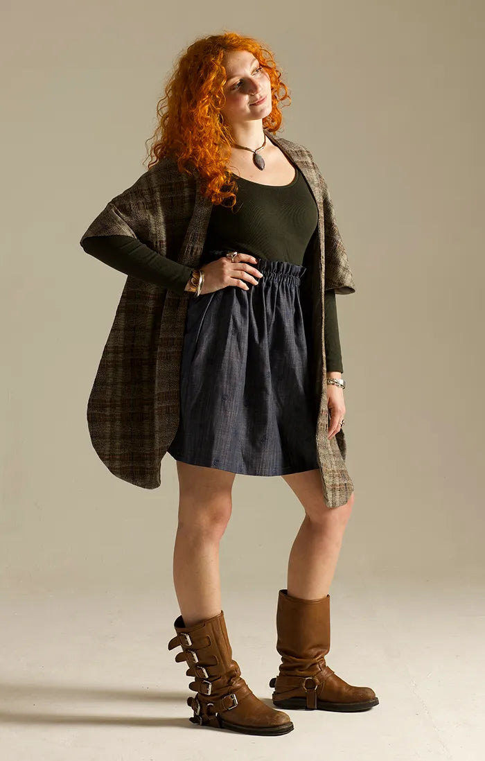 Woman wearing the Corvus Stole sewing pattern from Sew Different on The Fold Line. A fully lined stole or cape pattern made in wool, boucle, faux fur, or tweed fabric.