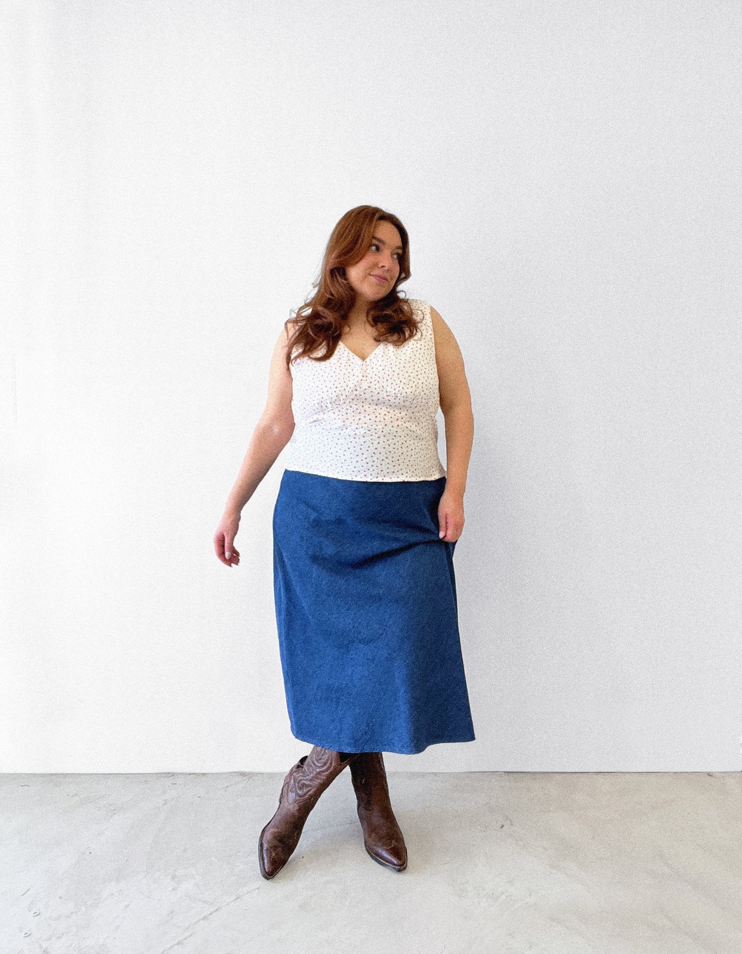 Woman wearing the Cove Blouse sewing pattern from Les Perlines on The Fold Line. A sleeveless blouse pattern made in rayon, viscose, cotton, linen, or tencel twill fabric, featuring a V-neck, gathers under the bust, and bias cut.