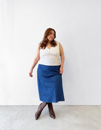 Woman wearing the Cove Blouse sewing pattern from Les Perlines on The Fold Line. A sleeveless blouse pattern made in rayon, viscose, cotton, linen, or tencel twill fabric, featuring a V-neck, gathers under the bust, and bias cut.