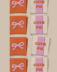 'Cutie Pie Bow Square' woven labels from Matchy Matchy Sewing Club on The Fold Line. The pack includes 8 woven labels to sew onto your handmade clothes and accessories.