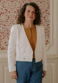 Woman wearing the Damas Jacket sewing pattern from Maison Fauve on The Fold Line. A jacket pattern made in jacquard, gabardine, denim, velvet, or fine wool fabric, featuring a structured cut, cropped length, pleats at the sleeve cap, and a low double-breasted closure.