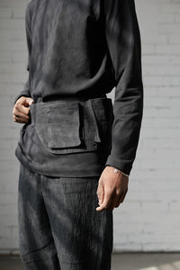 Man wearing the Davis Belt sewing pattern from Elbe Textiles on The Fold Line. A belt bag pattern made in denim or canvas fabric, featuring 3D patch pockets.