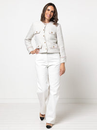 Woman wearing the Delphine Woven Jacket sewing pattern from Style Arc on The Fold Line. A jacket pattern made in wool, boucle, linen or linen blend, velvet, or sequin fabric, featuring a round neckline, button front, faux pocket flaps, two-piece sleeves, and fray edge trim.