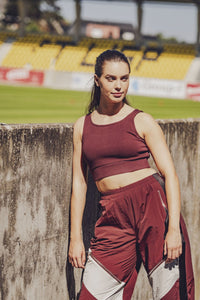 Woman wearing the Denver Top sewing pattern from Fibre Mood on The Fold Line. A sports top pattern made in stretch jersey, power stretch, rib knit, microfibre, or supplex-like fabric, featuring a close fit, cropped length, and elastic in the hem for support.