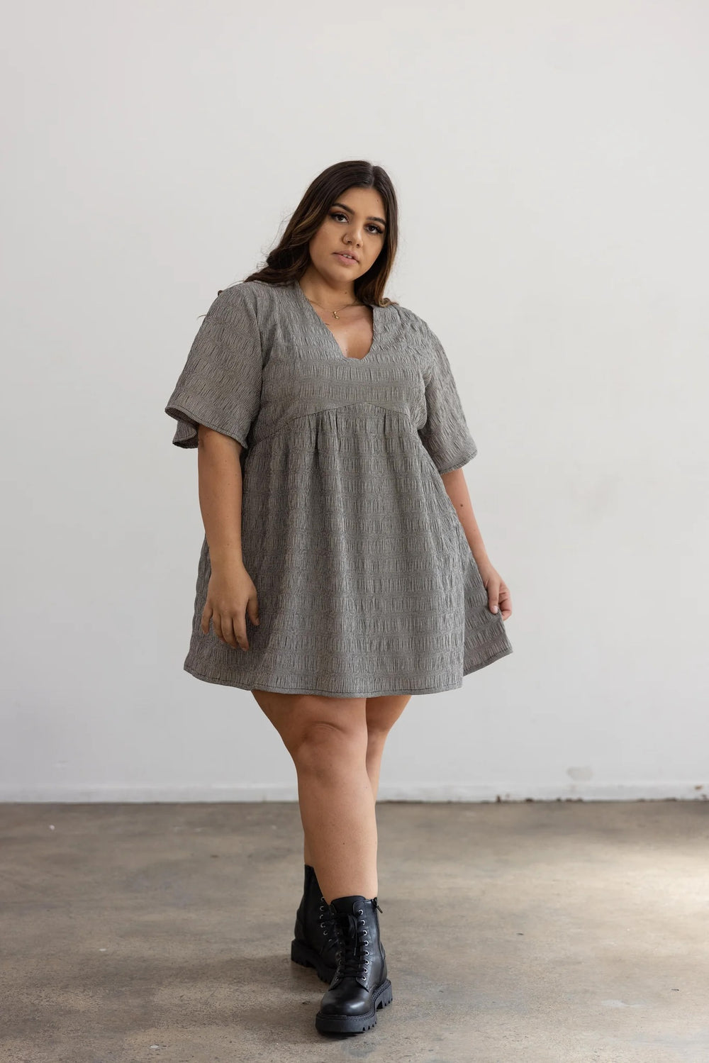 Woman wearing the Duplantier Dress sewing pattern from Elbe Textiles on The Fold Line. A dress pattern made in tencel, rayon, washed linen, silk noil, or soft cotton fabric, featuring a V-neckline, panelled bodice, mid length sleeves, gathered skirt, in-seam pockets, and mini length.