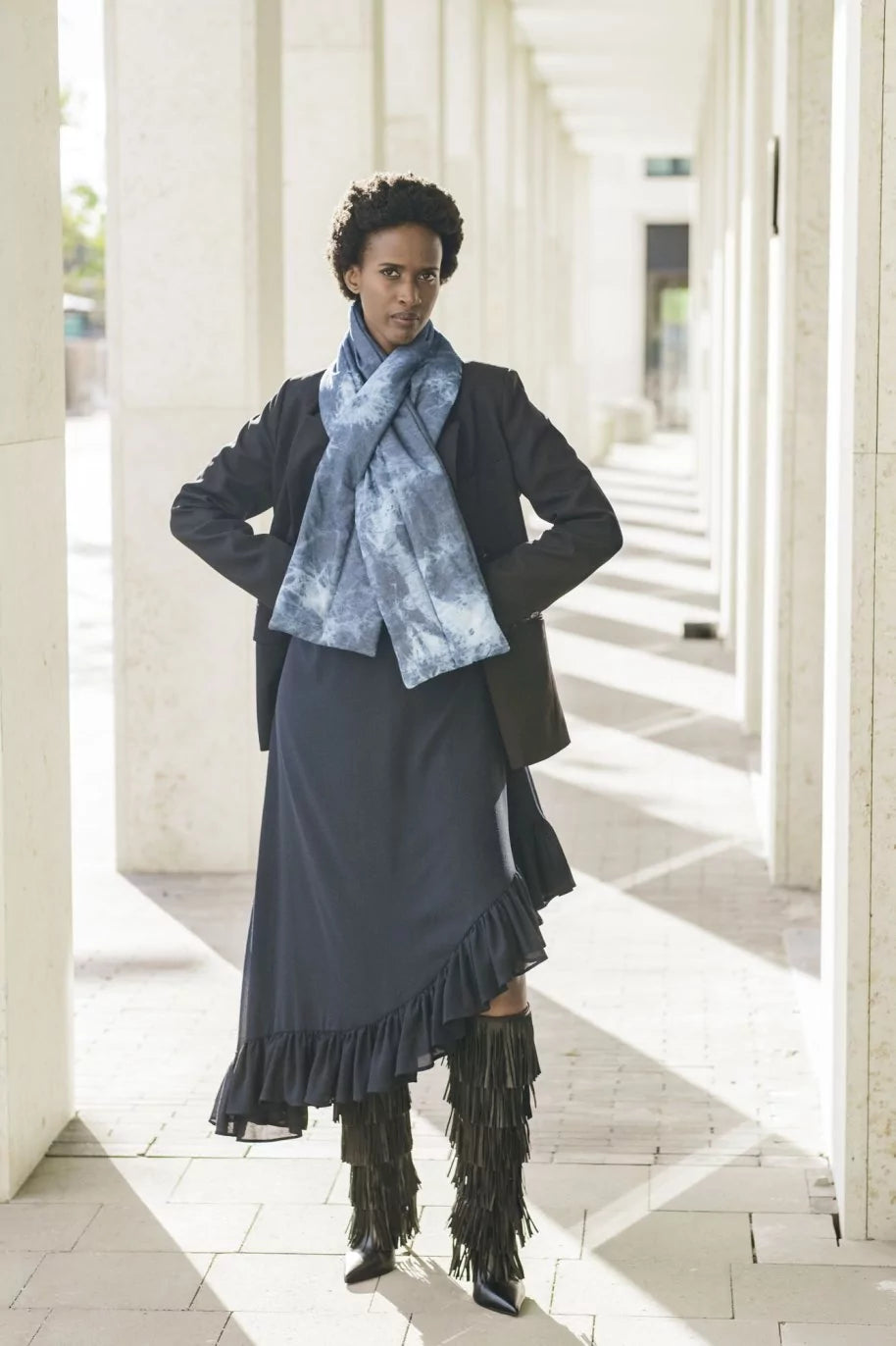 Woman wearing the Elmo Scarf sewing pattern from Fibre Mood on The Fold Line. A scarf pattern made in quilted, wool, or bouclé fabric, featuring a pull-through design.