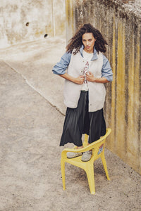 Woman wearing the Ember Bodywarmer sewing pattern from Fibre Mood on The Fold Line. A sleeveless bodywarmer pattern made in teddy (sherpa fleece) fabric, featuring an oversized cut, optional lining, bias bound edges, and snap closures.