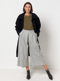 Woman wearing the Erin Woven Culottes sewing pattern from Style Arc on The Fold Line. A trousers pattern made in crepe, rayon, silk, charmeuse, or lightweight wool fabric, featuring a fitted waistband, 3/4 length wide legs, angled front pleats, and angled pockets.