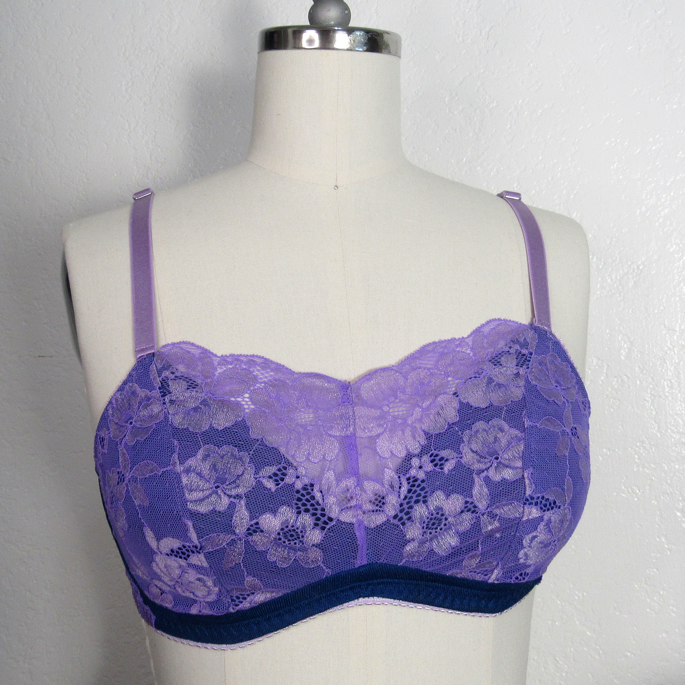The Faiza Wireless Bra sewing pattern from Primrose Dawn on The Fold Line. A bra pattern made in duoplex, dazzle tricot, stabilised tricot, sheer cup lining, or bra tulle fabric, featuring high V-neck lace cups over a low V-neck lining, with a cradle lace overlay.