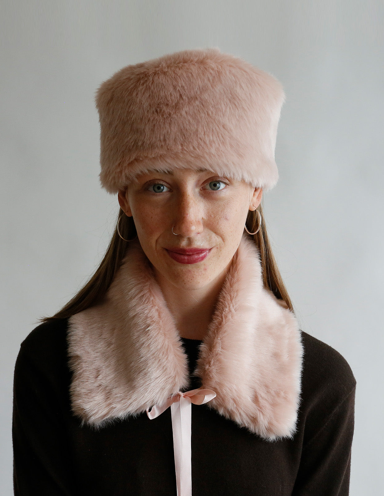 Woman wearing the Faux Fur Accessories sewing pattern from The Maker's Atelier on The Fold Line. An accessories pattern made in faux fur fabric, featuring a hat and collar.