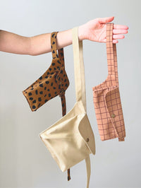 The Filippa Bag sewing pattern from Notches on The Fold Line. A belt bag pattern made in medium weight fabric, featuring three sizes, a snap closure, and adjustable strap.