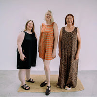 Women wearing the Foy Jumpsuit sewing pattern from Little Rosy Cheeks on The Fold Line. A sleeveless jumpsuit or playsuit pattern made in cotton, denim, needlecord, linen, linen blends, double gauze, or viscose fabric, featuring bust darts, patch pockets, a scooped back with elastic, and short or long wide legs.