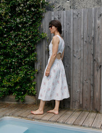 Woman wearing the Frisson Dress sewing pattern from Atelier Scämmit on The Fold Line. A sleeveless dress pattern made in viscose, silk, or linen fabric, featuring a lining, side ties, gathered back opening, and midi length.