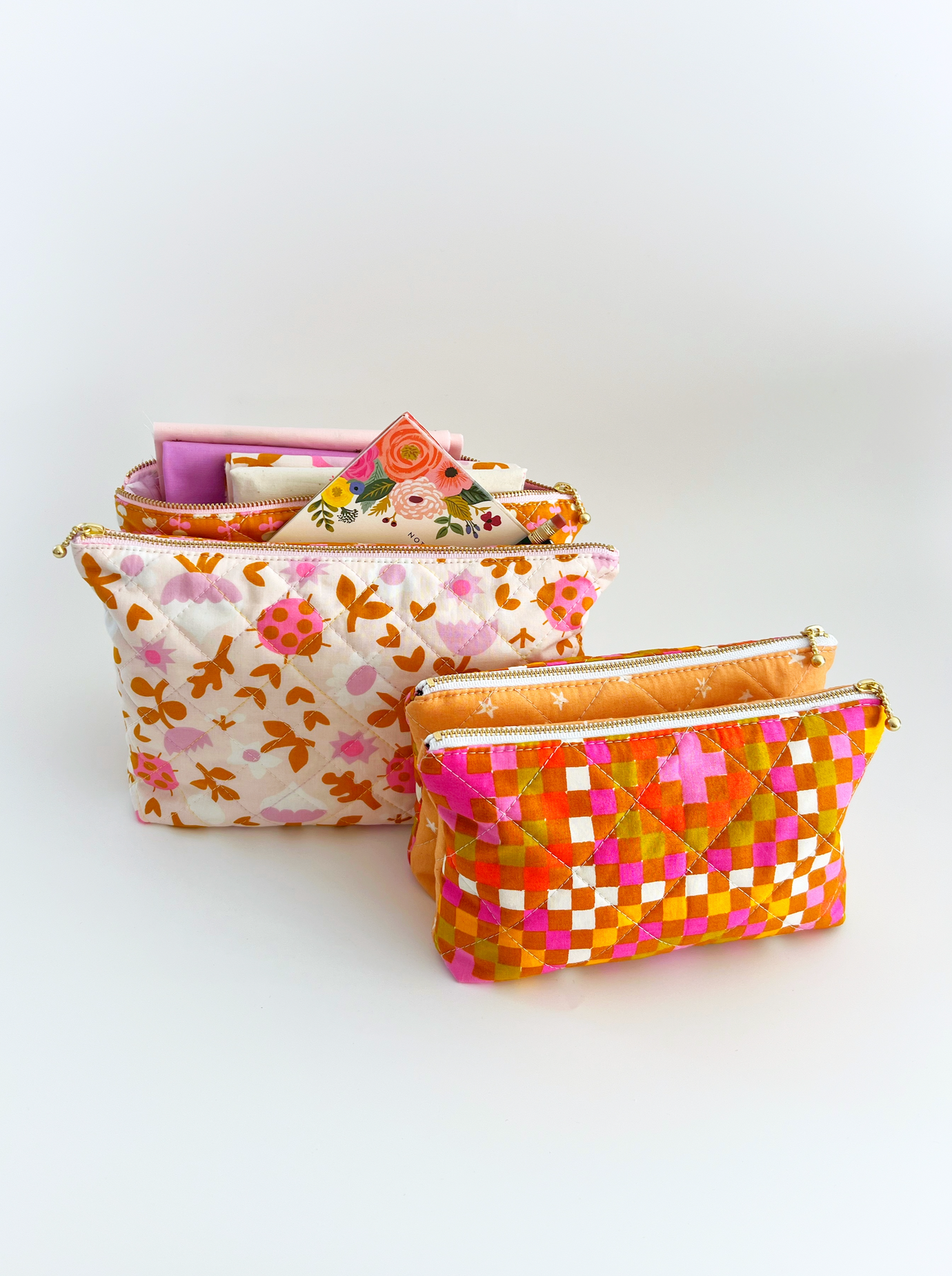 The Gemini Pouch sewing pattern from Lou Orth Designs on The Fold Line. A quilted bag pattern made in cotton fabric, featuring two zip compartments with a slip pocket in the middle.