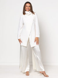 Woman wearing the Genevieve Jacket sewing pattern from Style Arc on The Fold Line. A jacket pattern made in wool cashmere, boiled wool, ponte, or jacket weight linen fabric, featuring a large shawl collar, angled seams and darts, an asymmetrical zip front, two-piece sleeves, and in-seam pockets.